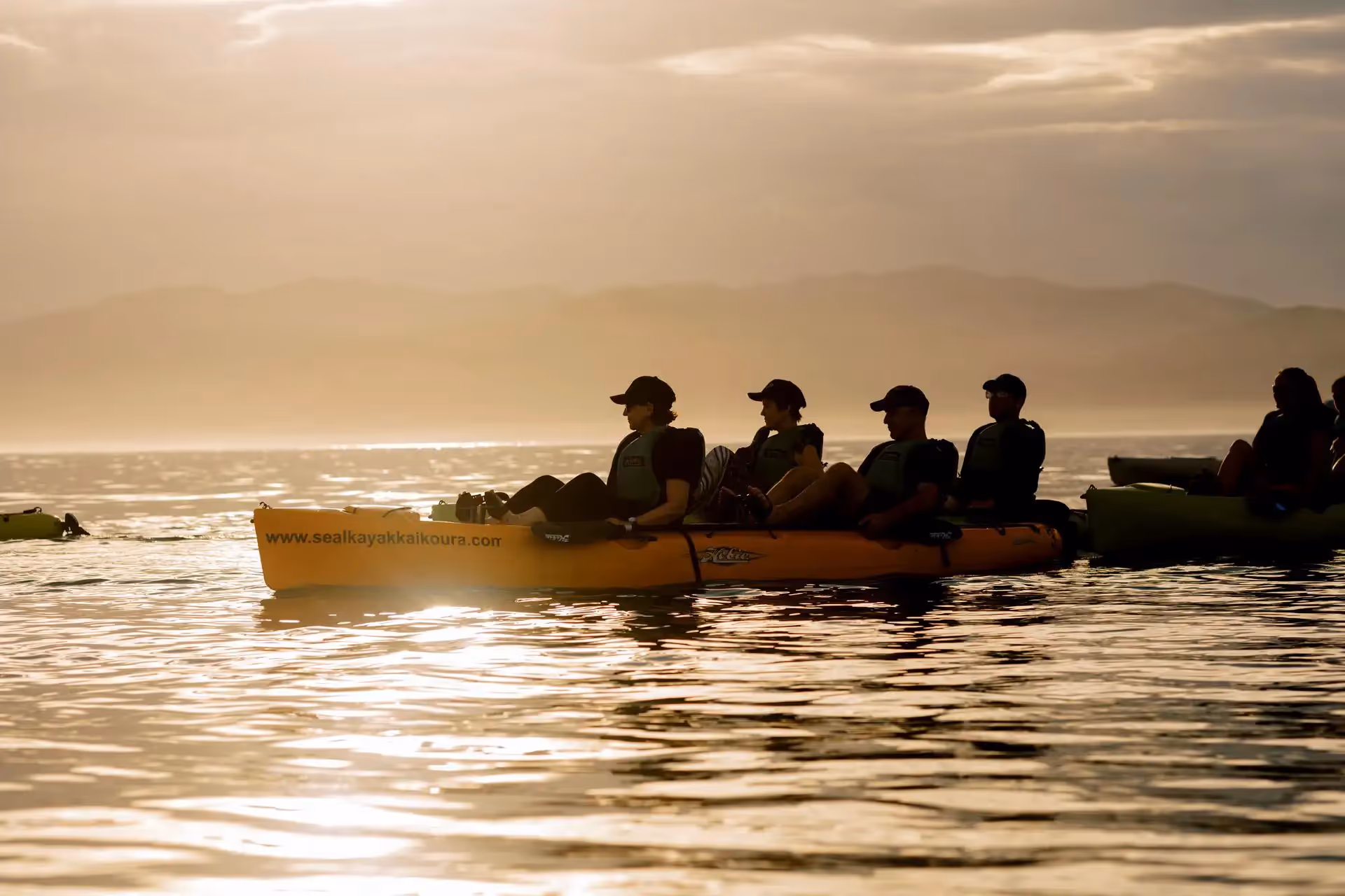 Kayaks on the water at sunset