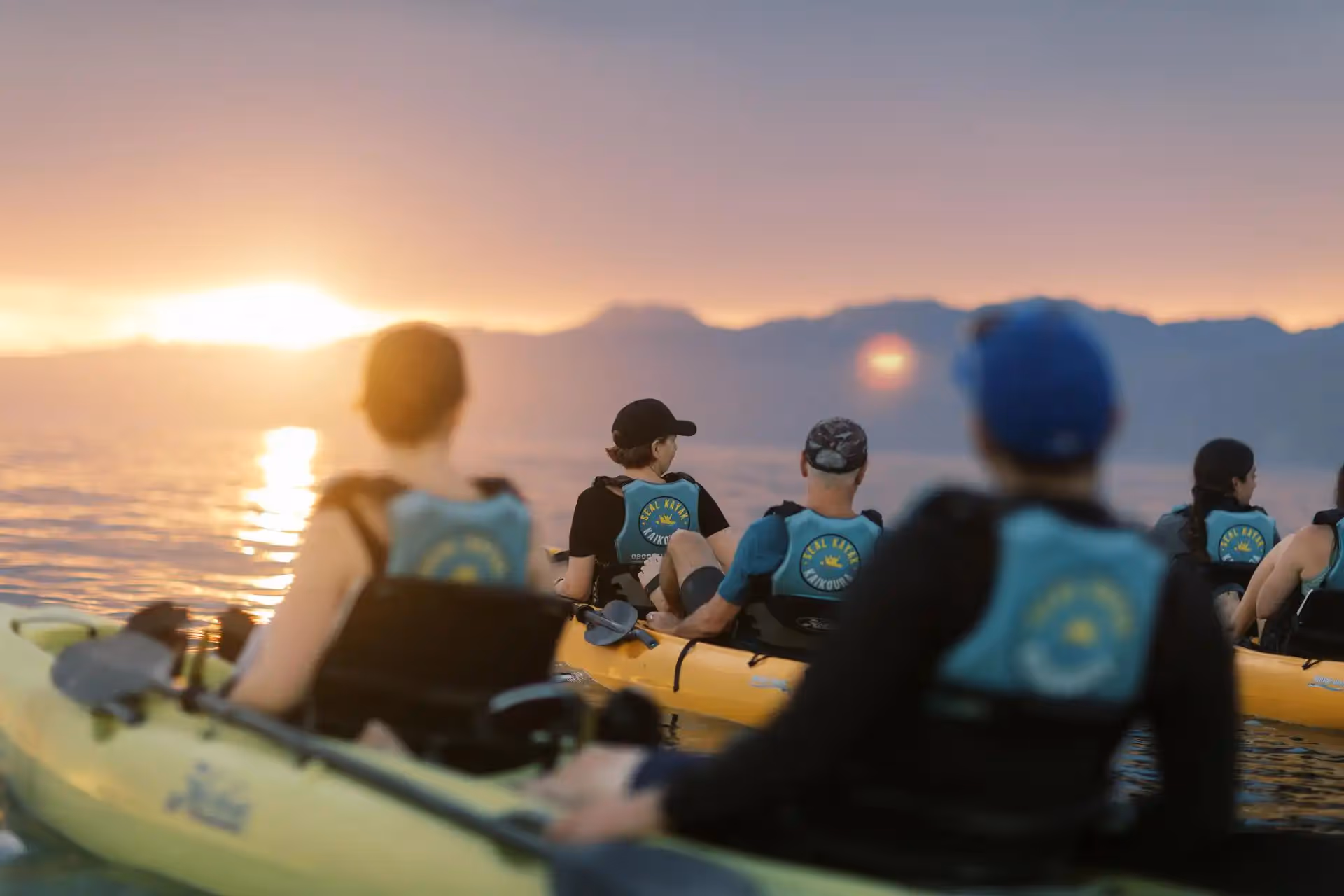 Kayaks on the water at sunset
