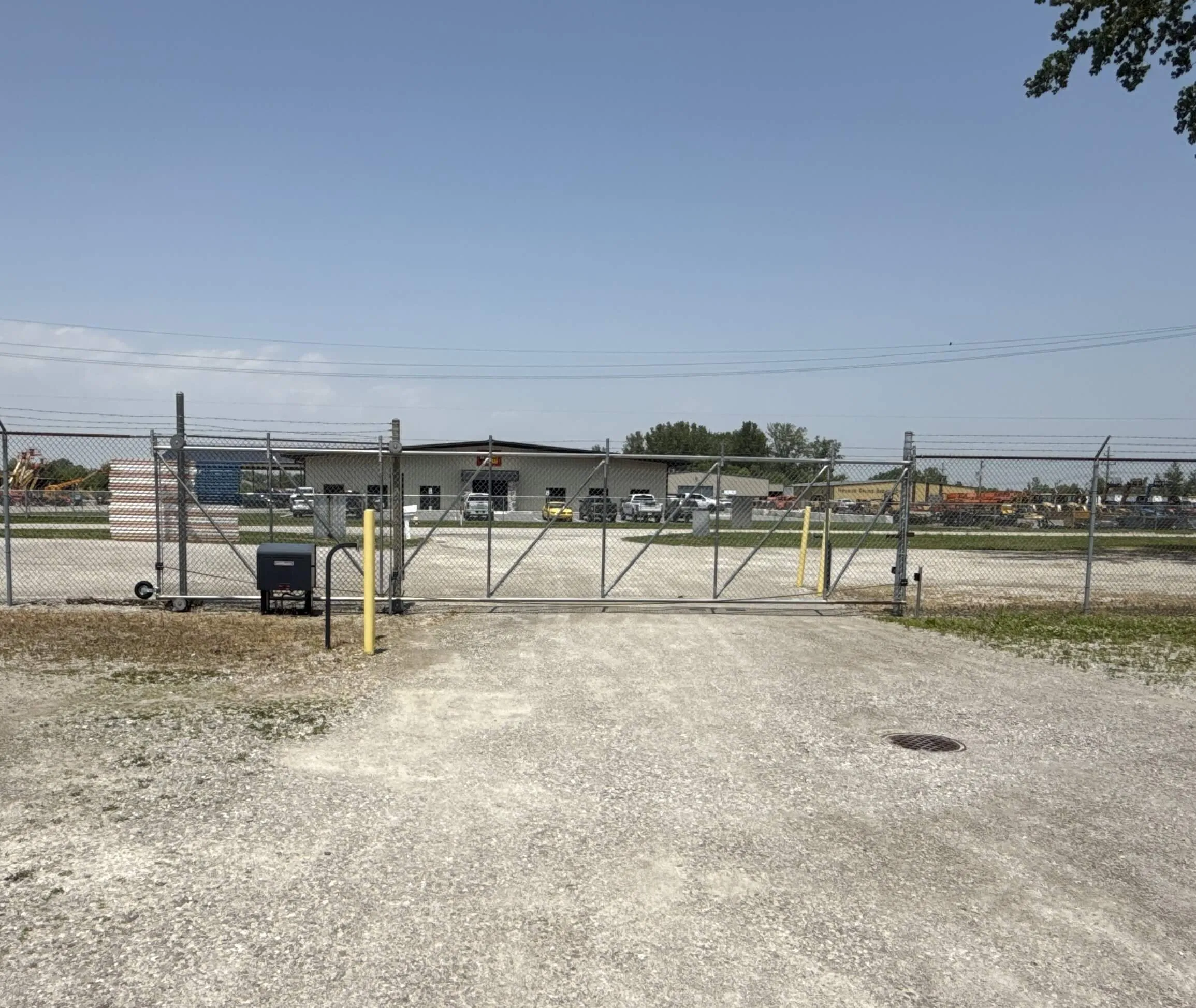 Th entras of a sef storage facility  with a fence and a gate