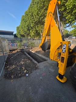 Surface Materials being removed with Backhoe loader