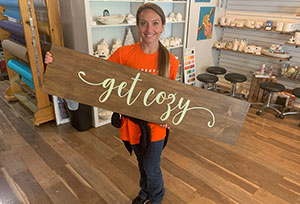 a person holding a custom wood sign