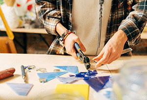 person making a fused glass project