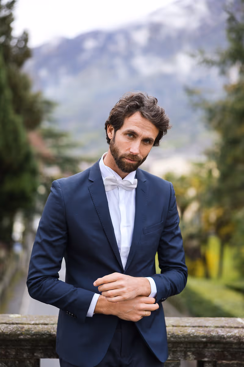 Groom fixing his cufflinks looking calm and cool. 