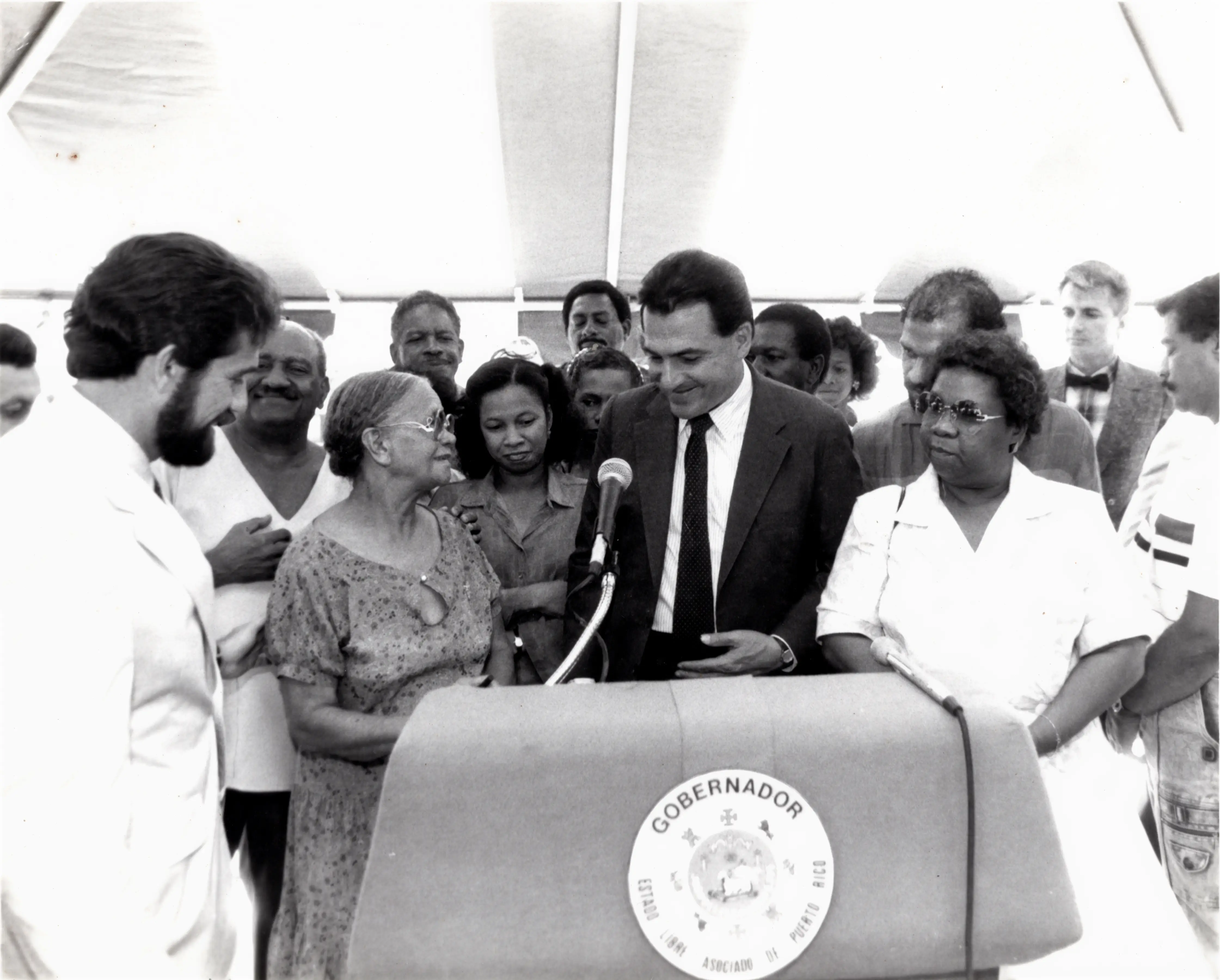 Ceremonia de la primera piedra en la Plaza de los Salseros en Playita, San Juan. Otorgada por Rafael Hernandez Colon a Dona Margot, demás familiares y allegados de Ismael Rivera. 1987. Fuente: Archivo de la Fundación Ismael Rivera.