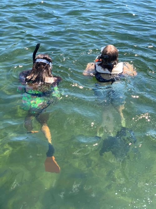 Two TVM students snorkeling in the ocean on a field trip.