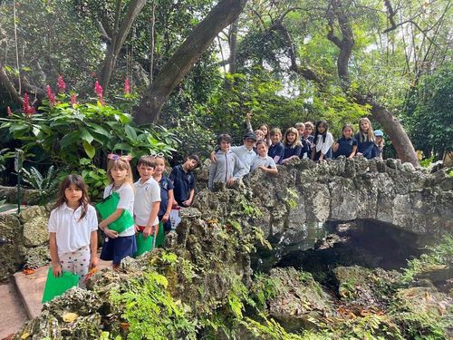 TVM students lined up on a rock bridge posing for a photo during a school field trip.