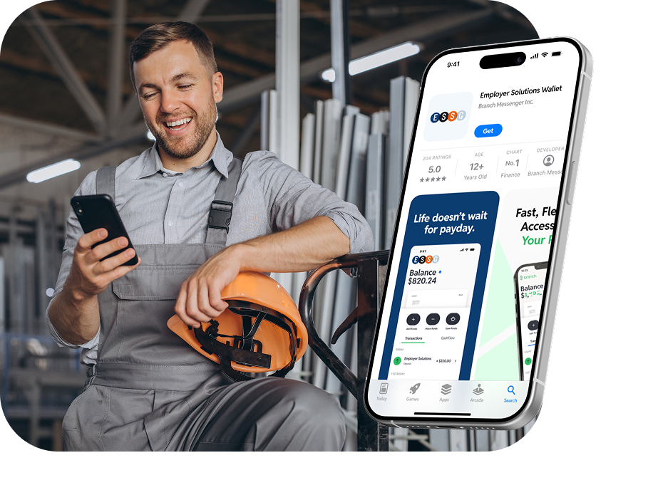 Smiling worker in gray overalls holding orange hard hat and looking at a phone with a finance app display.