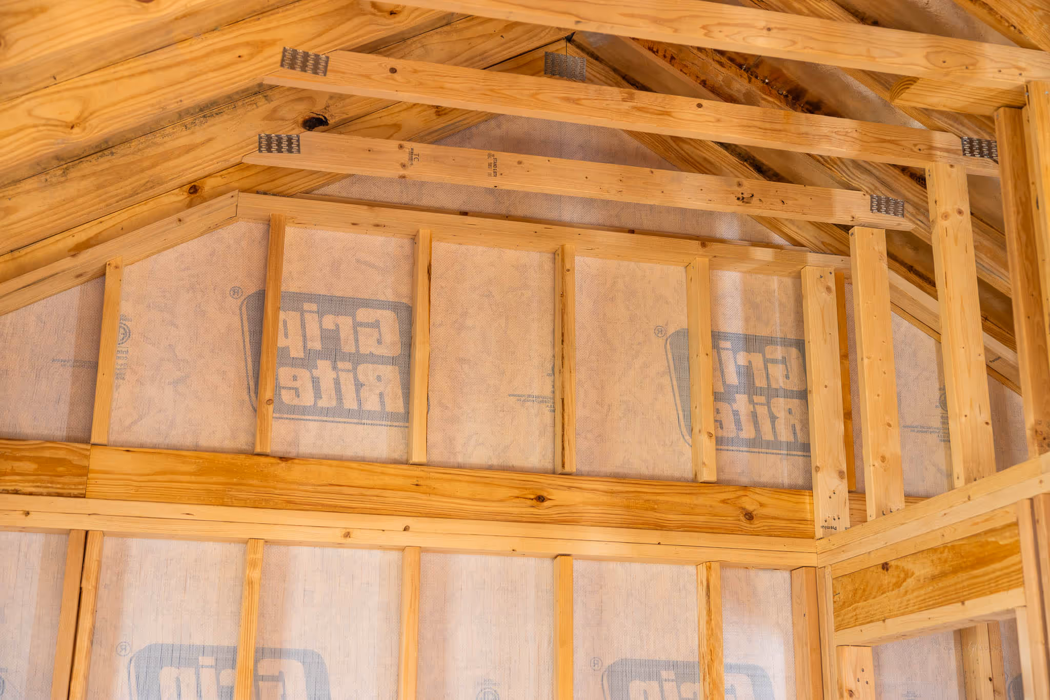 gable end of a cabin shell with deadwood and more studs