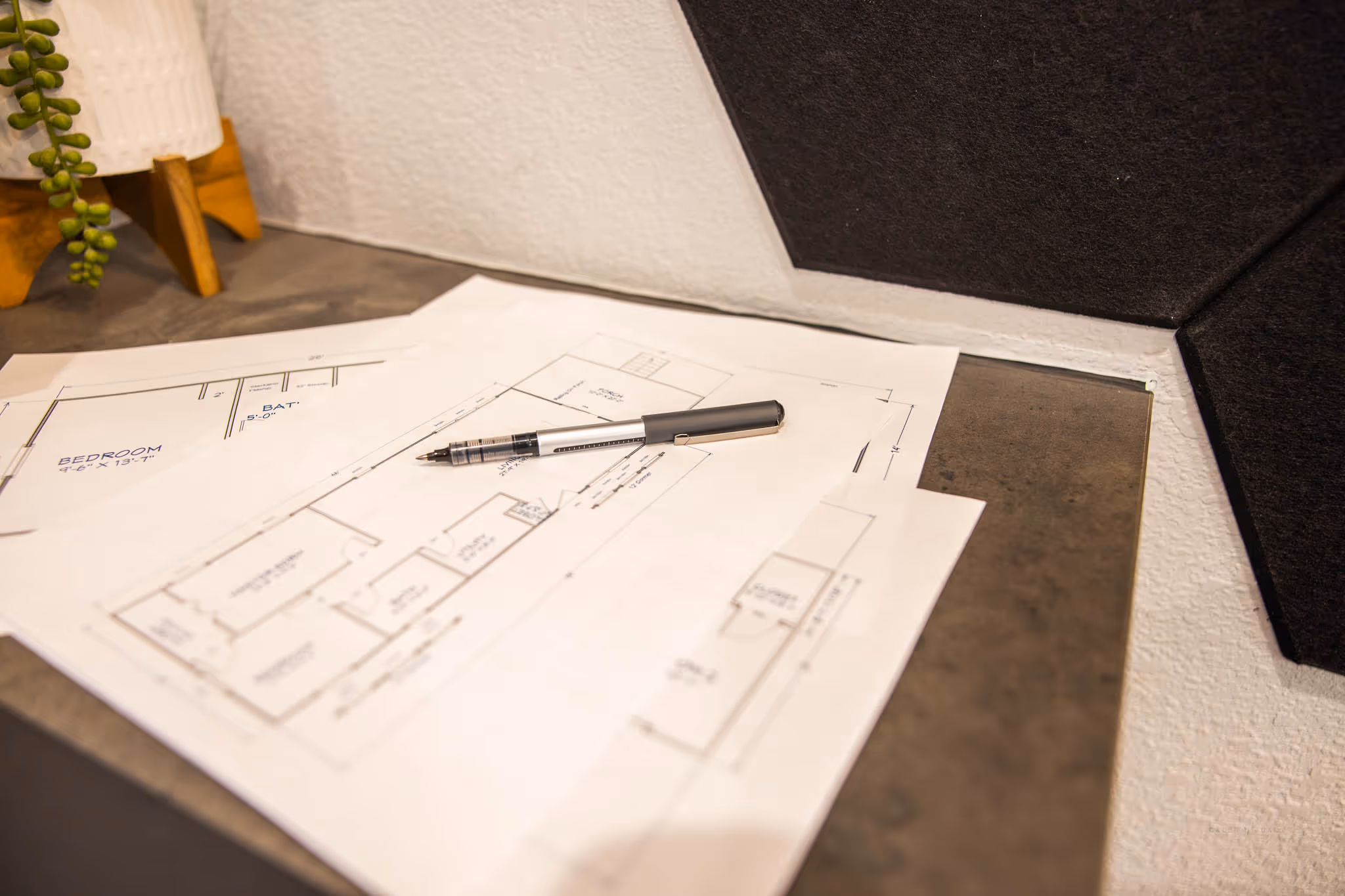 floor plans for cabin shells on a desk with a pen on top