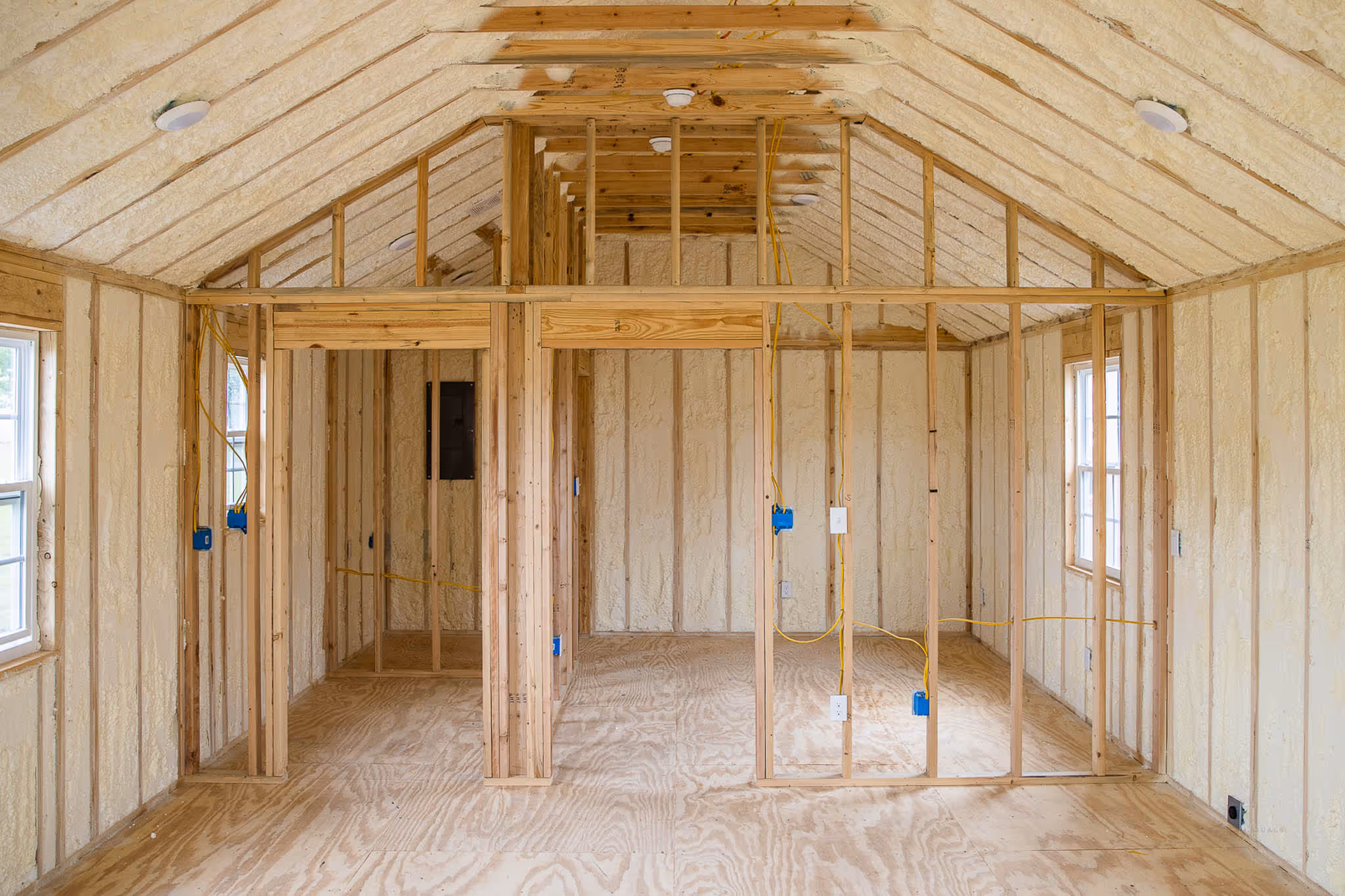 interior of a cabin shell with spray foam and electrical and interior wall framing