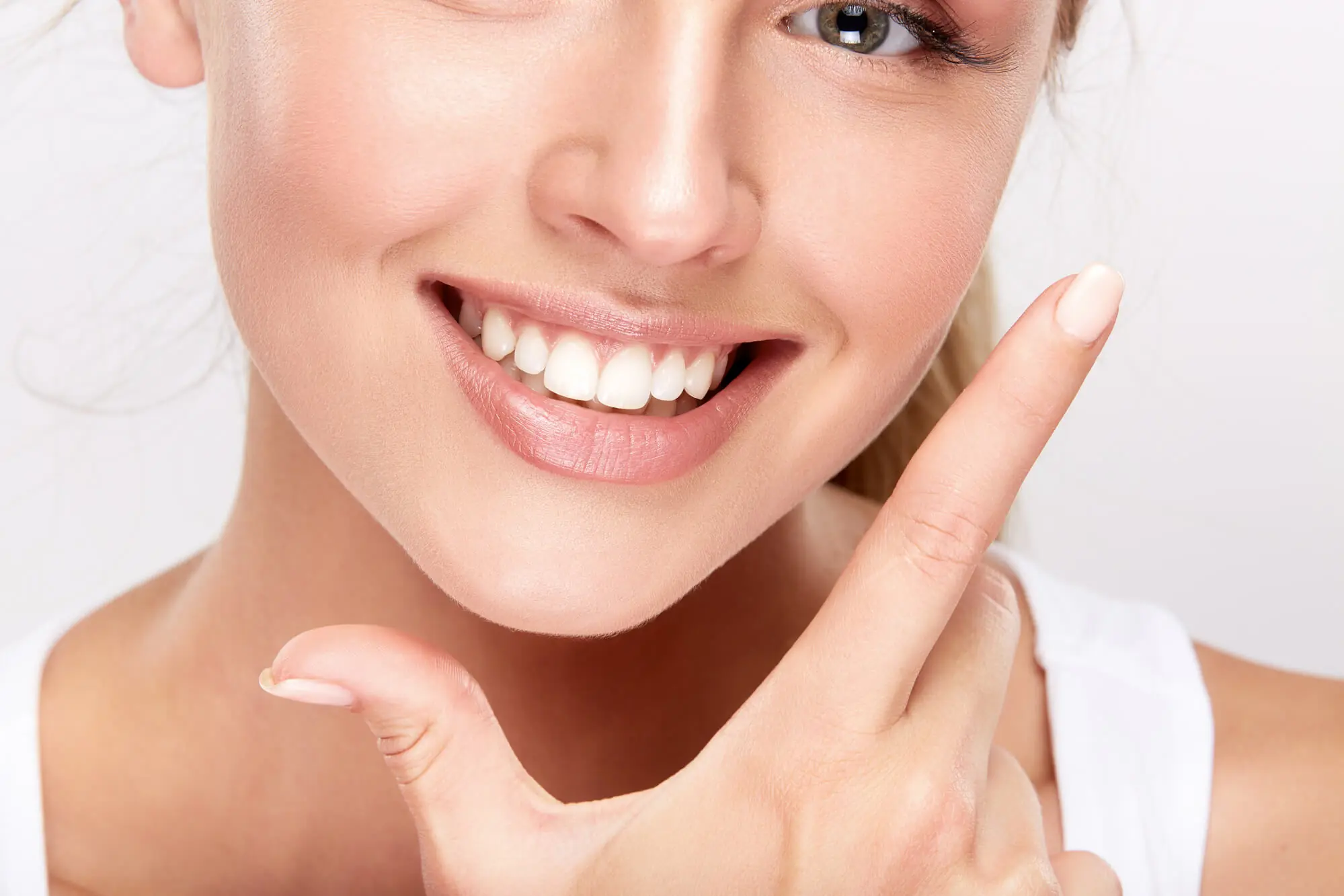 a woman smiling with her hand on her chin