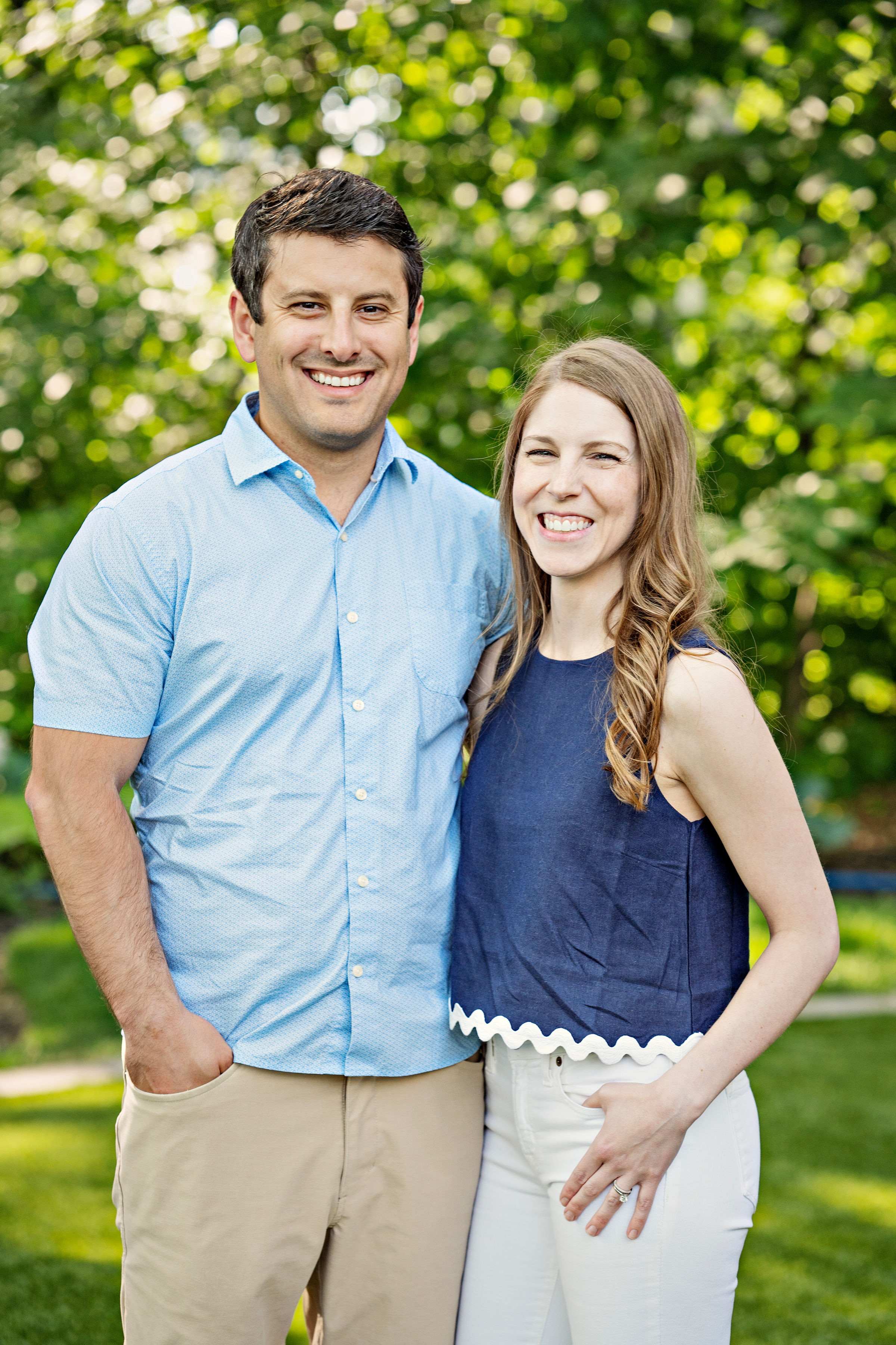 A man and a woman smiling with their arms around each other