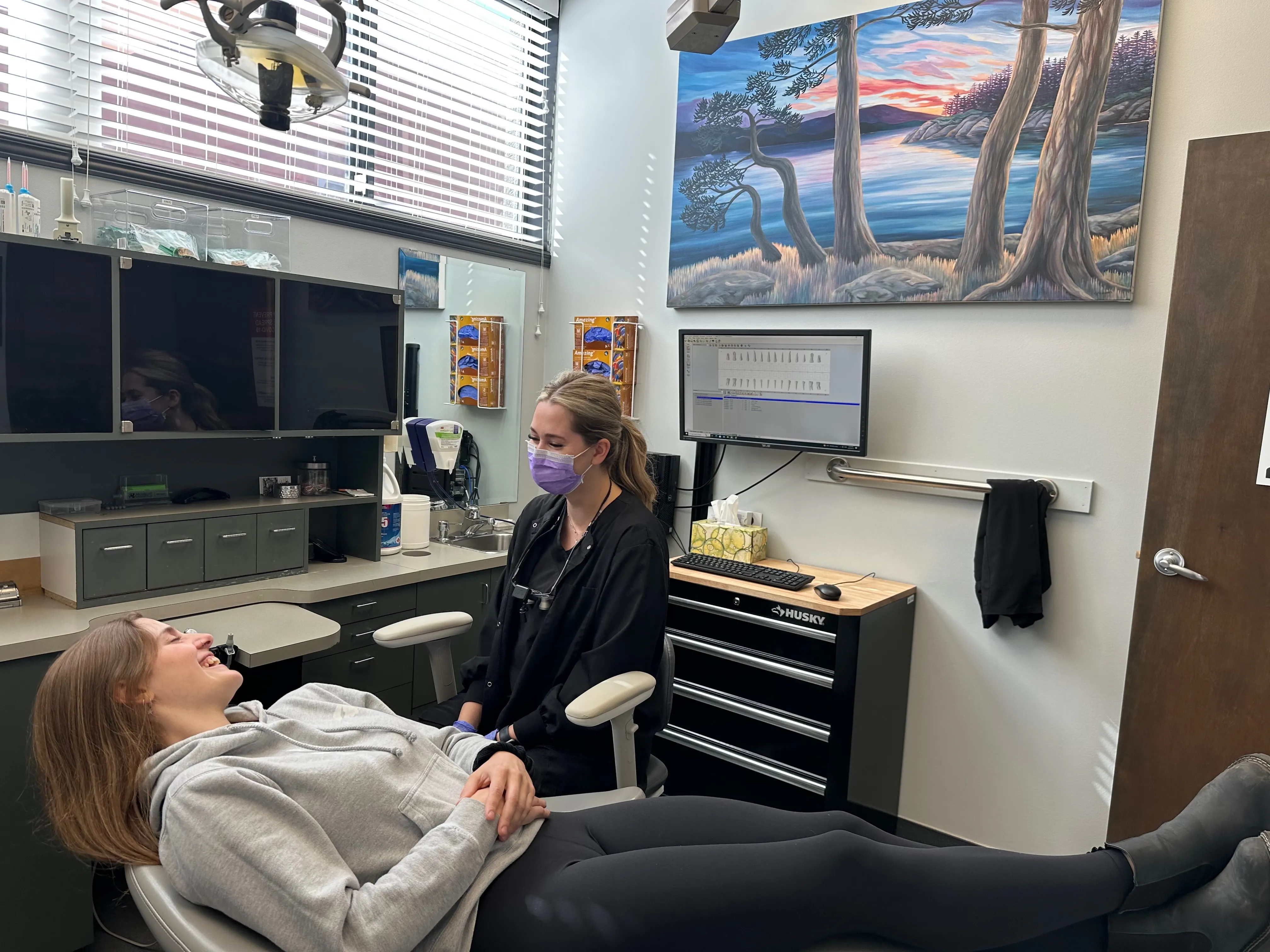Dental hygienist with a patient in the treatment chair at Metral Dental