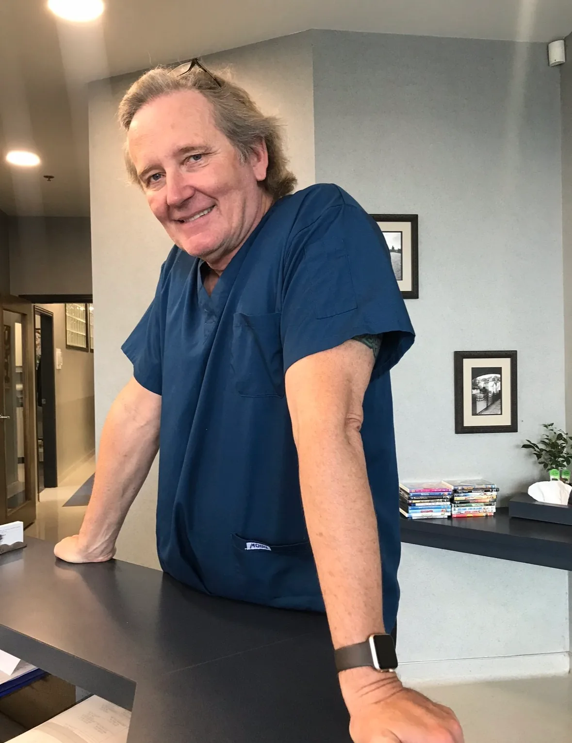 Patient in dentist chair at Metral Dental office with a dental assistant sitting beside chair