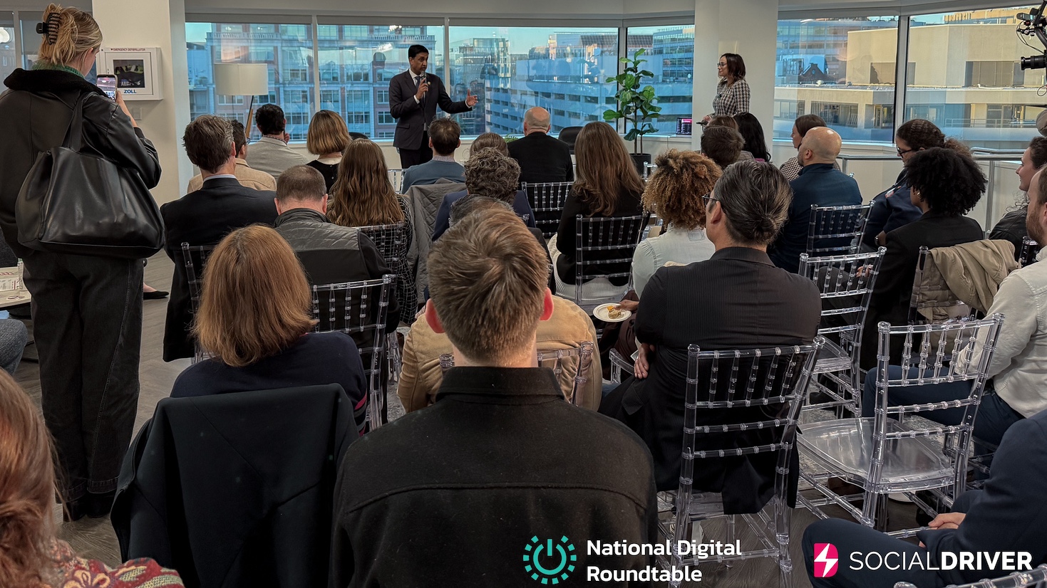 Congressman Ro Khanna speaks to an audience at the Creators 4 Mental Health DC event hosted by Social Driver and the National Digital Roundtable, with city views in the background.
