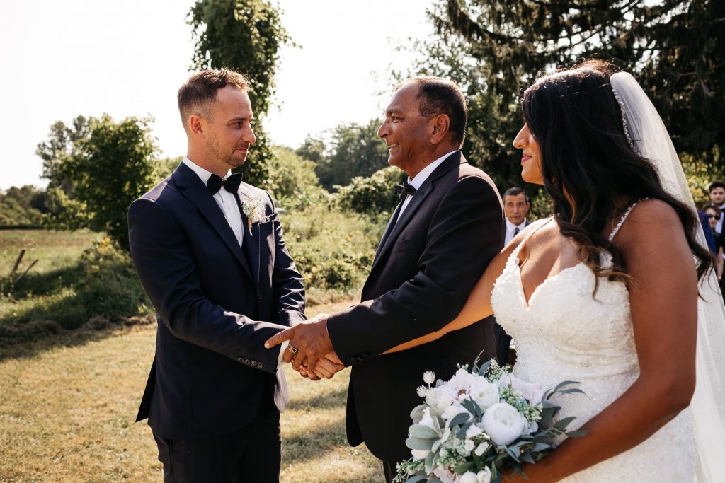 father shakes groom's hand pec wedding