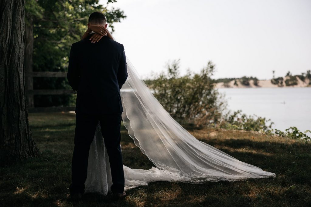 bride and groom embrace at sandbanks first look
