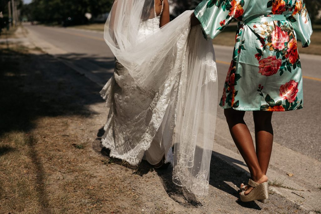 MOH carries bride's dress to sandbanks first look