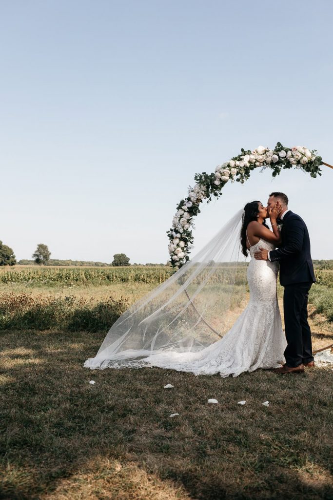 bride and groom kiss at pec backyard wedding