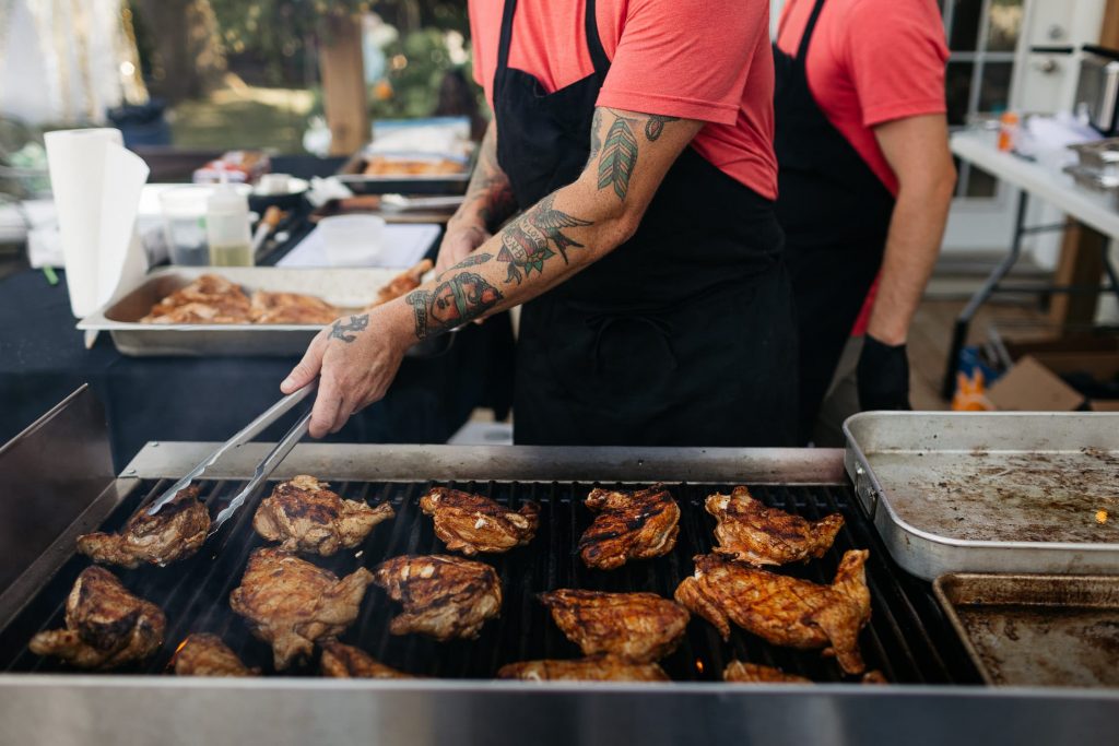 eat with matt demille grilling chicken at backyard wedding