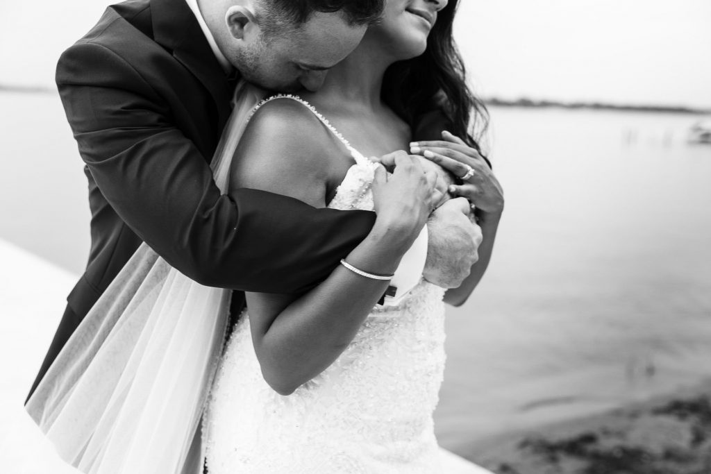 bride and groom snuggle at sunset west lake wedding