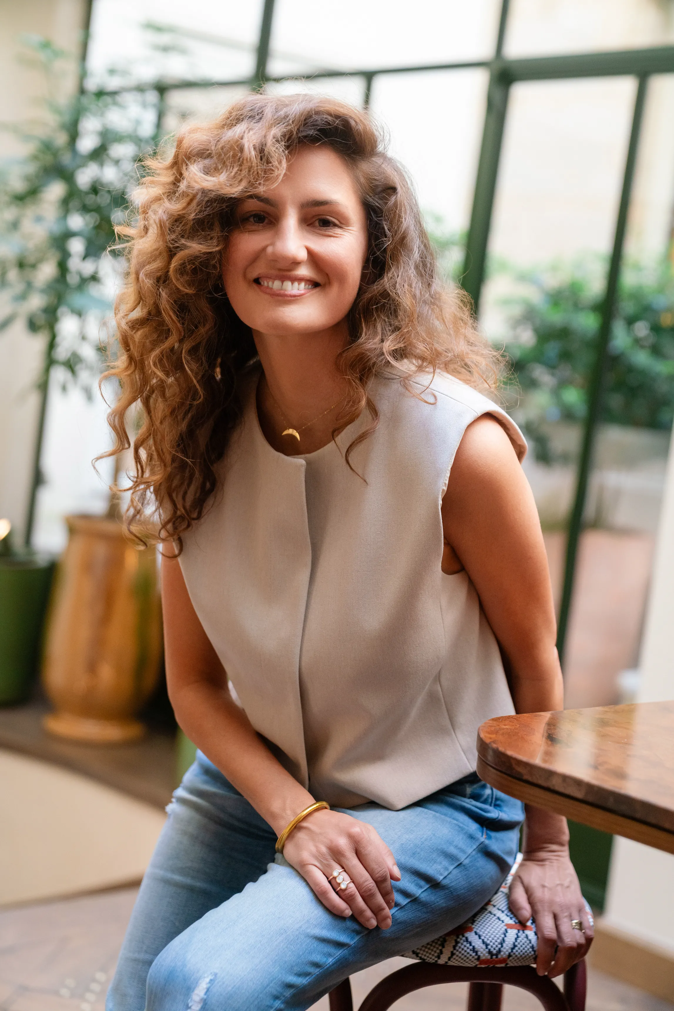 a woman sitting in a chair with her legs crossed