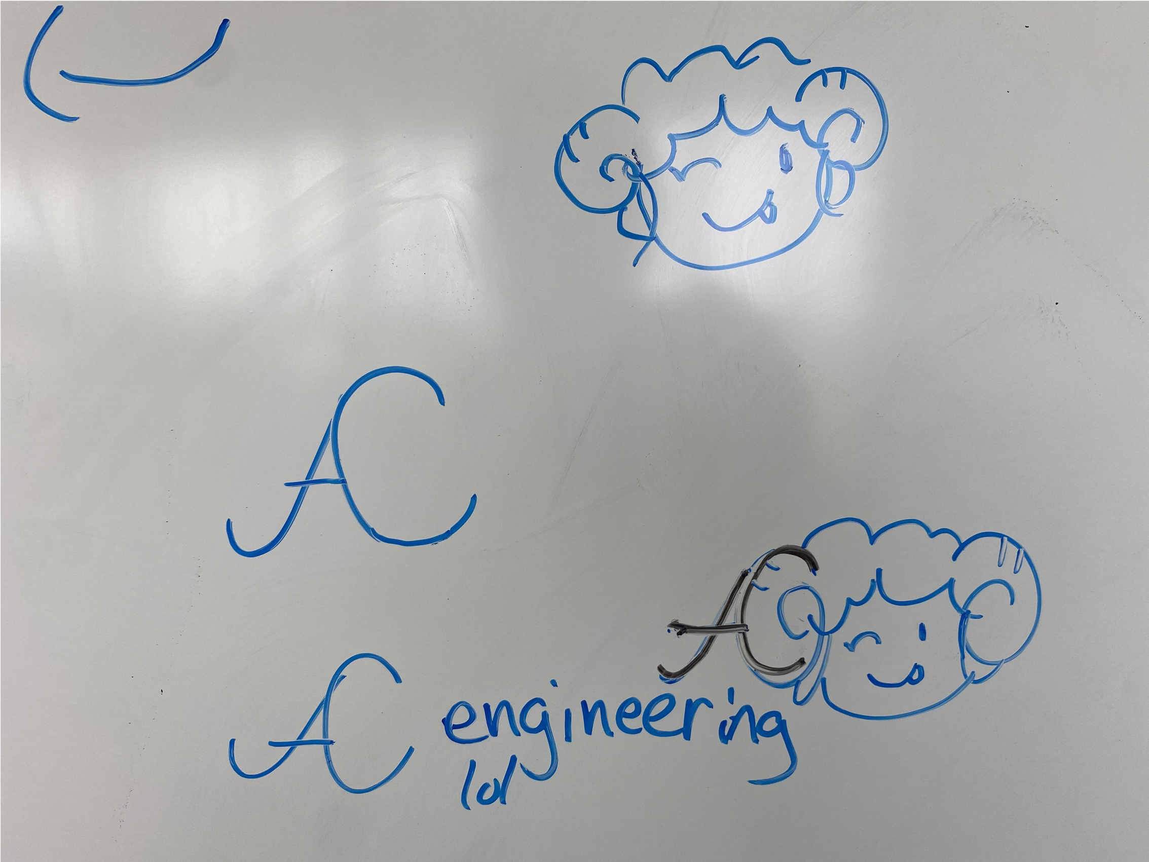 Drawings of AC and a sheep on a whiteboard with blue dry erase marker