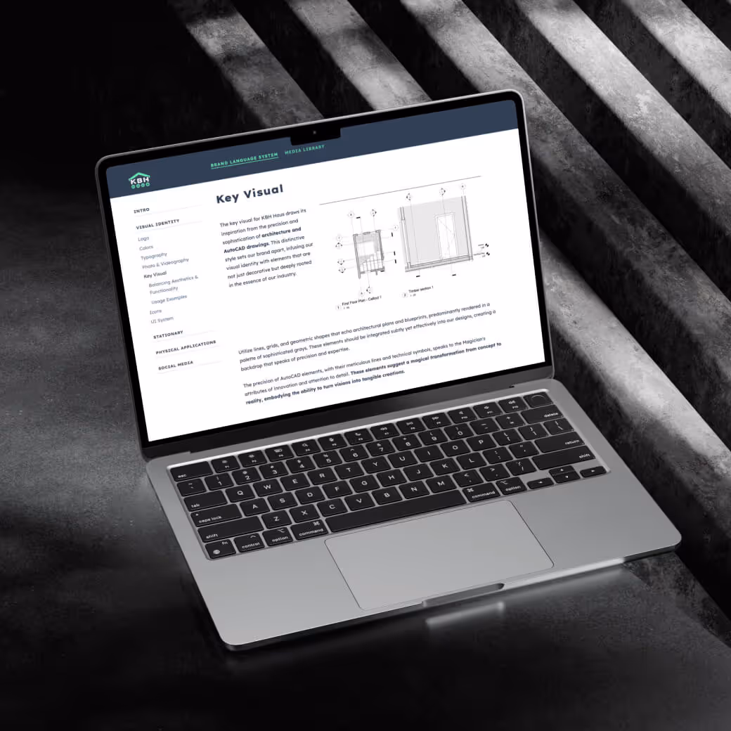 A laptop with the online brand book shows the key visual guidelines
