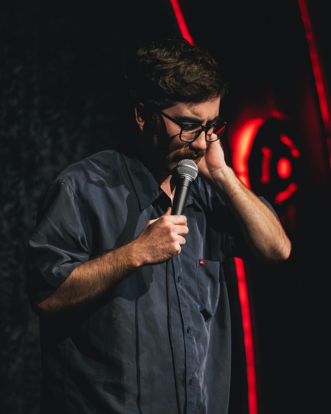 A man holding a microphone up to his face.