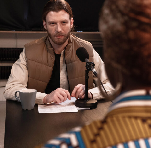 Person directing an interview for a podcast episode