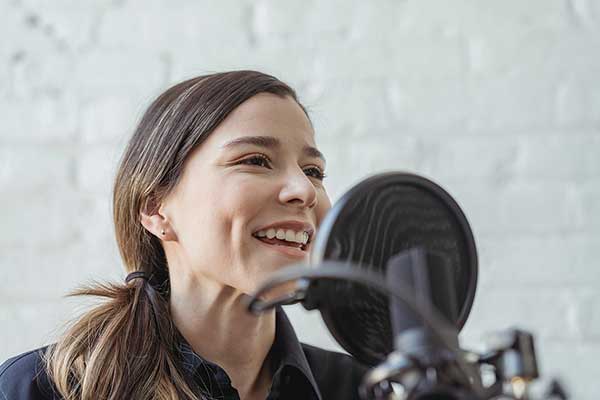 Person talking on the microphone on a podcast 