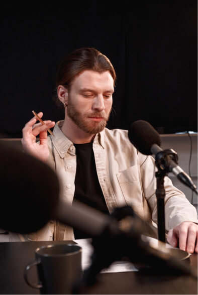 Man on a chair talking at microphone