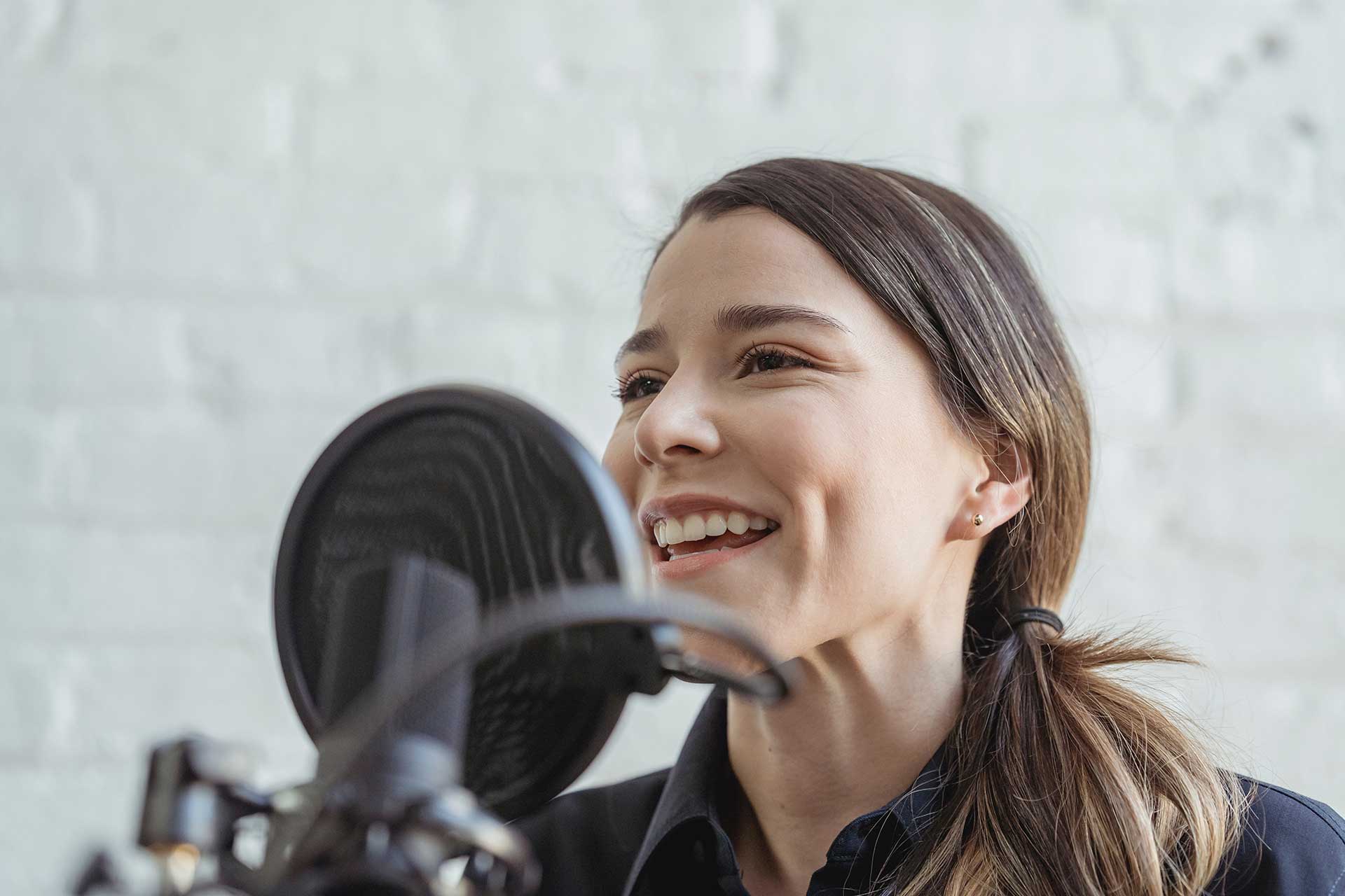 Person talking on the microphone on a podcast