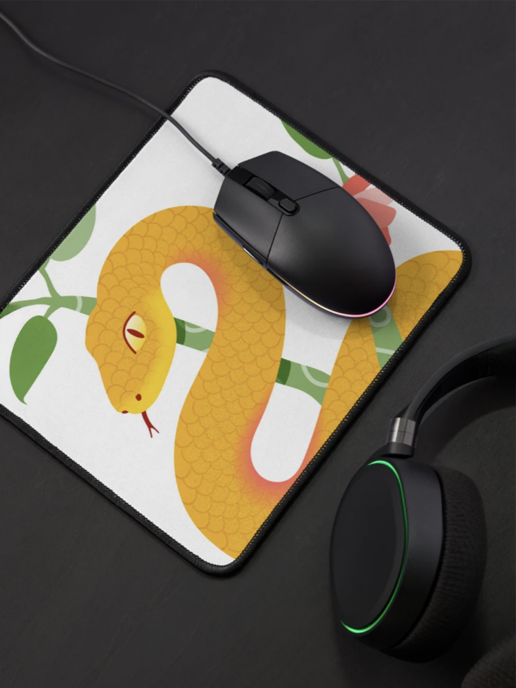 mouse pad with illustration of a snake in a tree with flowers