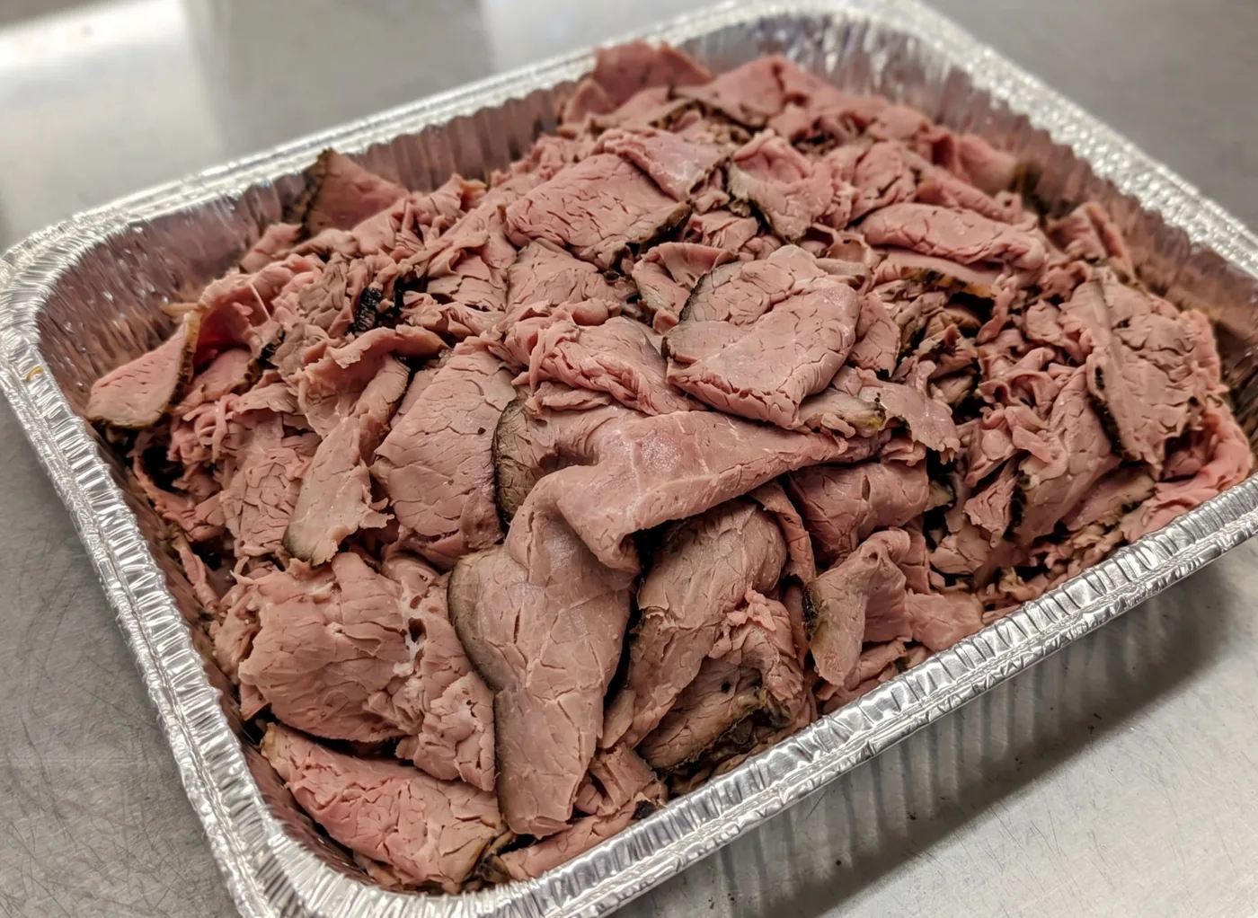 Freshly sliced Baltimore-style pit beef in a catering tray from 700 South Deli and Catering in Linthicum Heights, Maryland