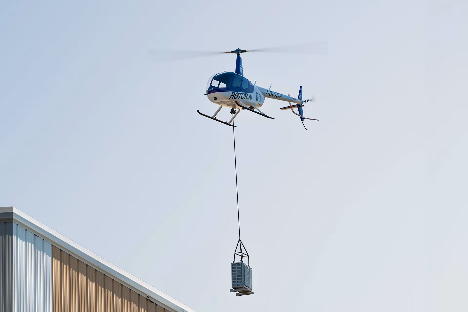 Unmanned helicopter lifting cargo with the RPX flight system from Rotor.