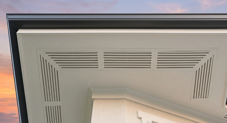 White wooden soffit with integrated vent panels beneath a residential roof overhang.