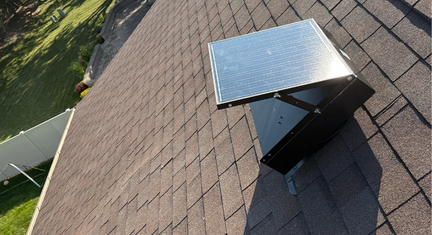 Solar attic fan installed on an asphalt shingle roof to help ventilate attic heat.