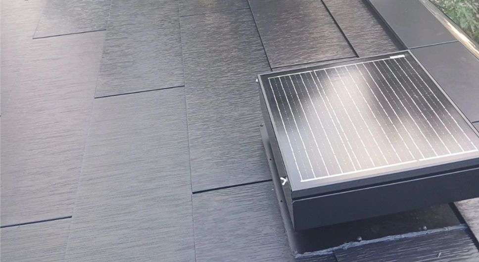 Attic solar fan installed on an Tesla solar roof to help ventilate attic heat.