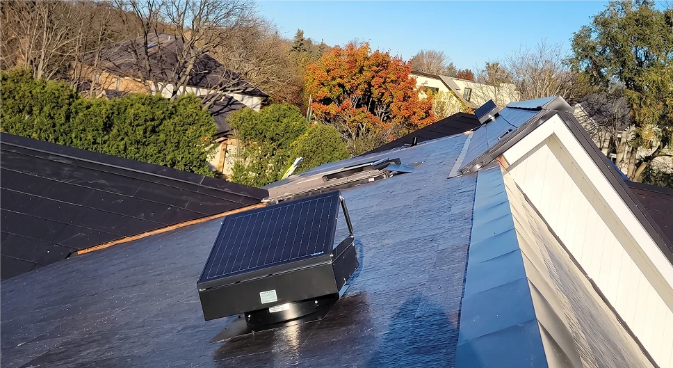Attic solar fan installed on a Tesla solar roof.