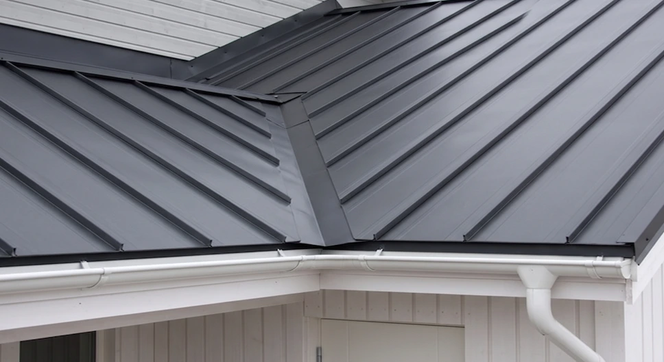 Finished standing seam metal roof with clean valley and roofline details.