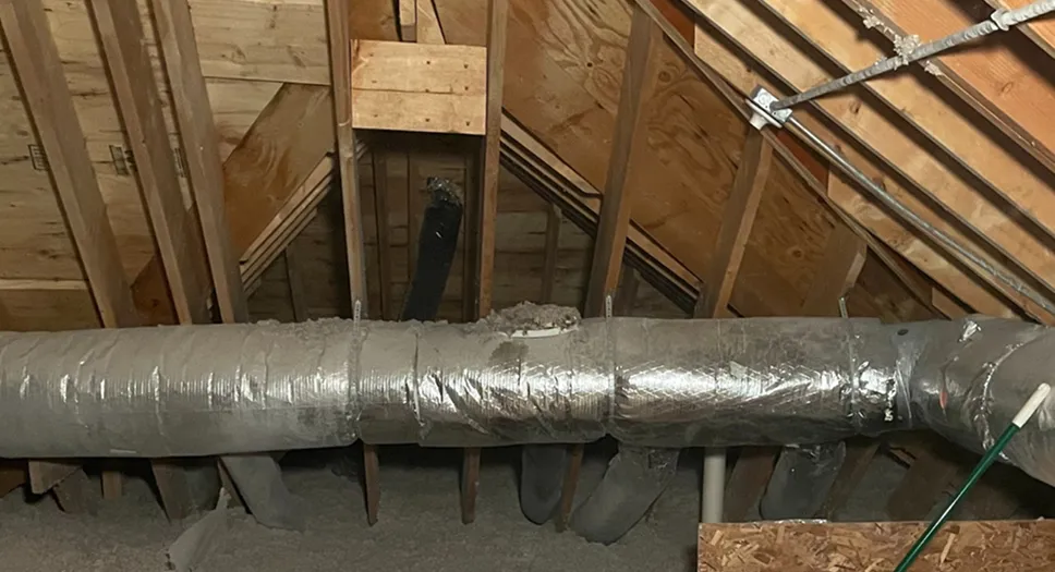 Attic ductwork installed above insulation to support ventilation and home airflow.