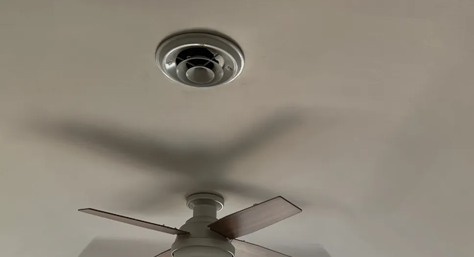 Whole house fan ceiling vent installed inside a home for indoor air circulation.