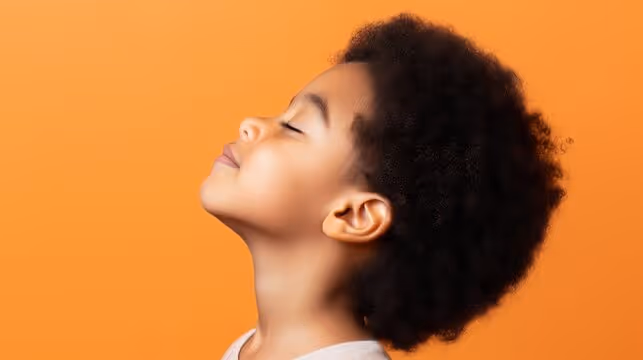 A young woman with an afro is looking up.