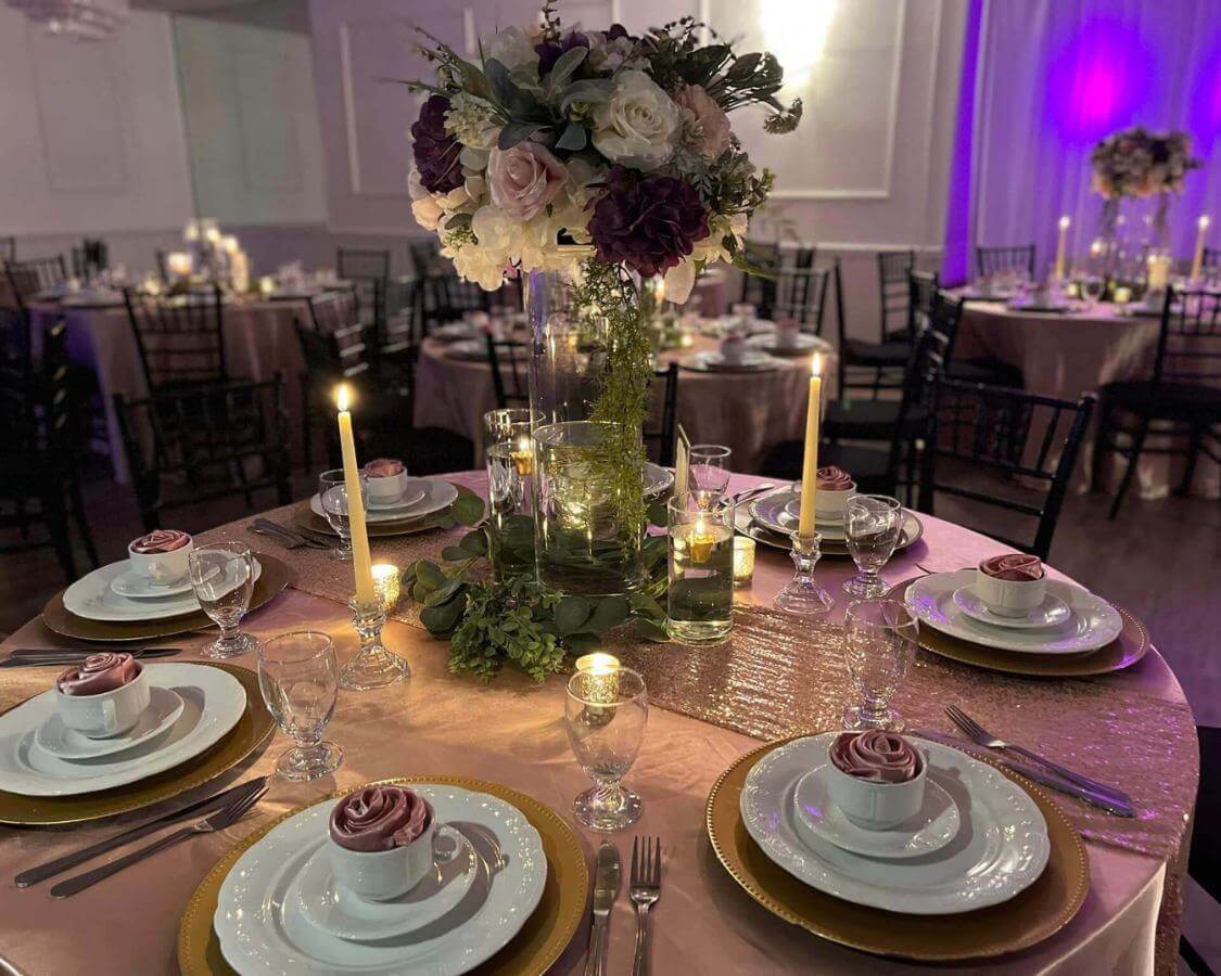 Elegant layered cake adorned with delicate pink flowers, showcased on a stunning gold, white, and pink decoration, celebrating a memorable 60th birthday milestone at The Palmyra Venue in New Jersey.