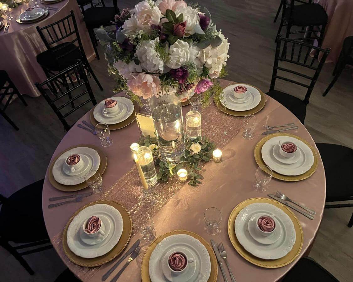Exquisite purple and cream floral centerpieces gracing the table decor at The Palmyra Venue.