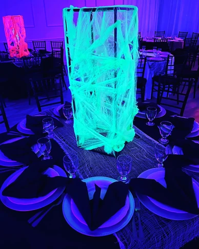 Scary-themed table with black bat-shaped napkins and a vase covered in glow-in-the-dark wrap at The Palmyra Venue, New Jersey