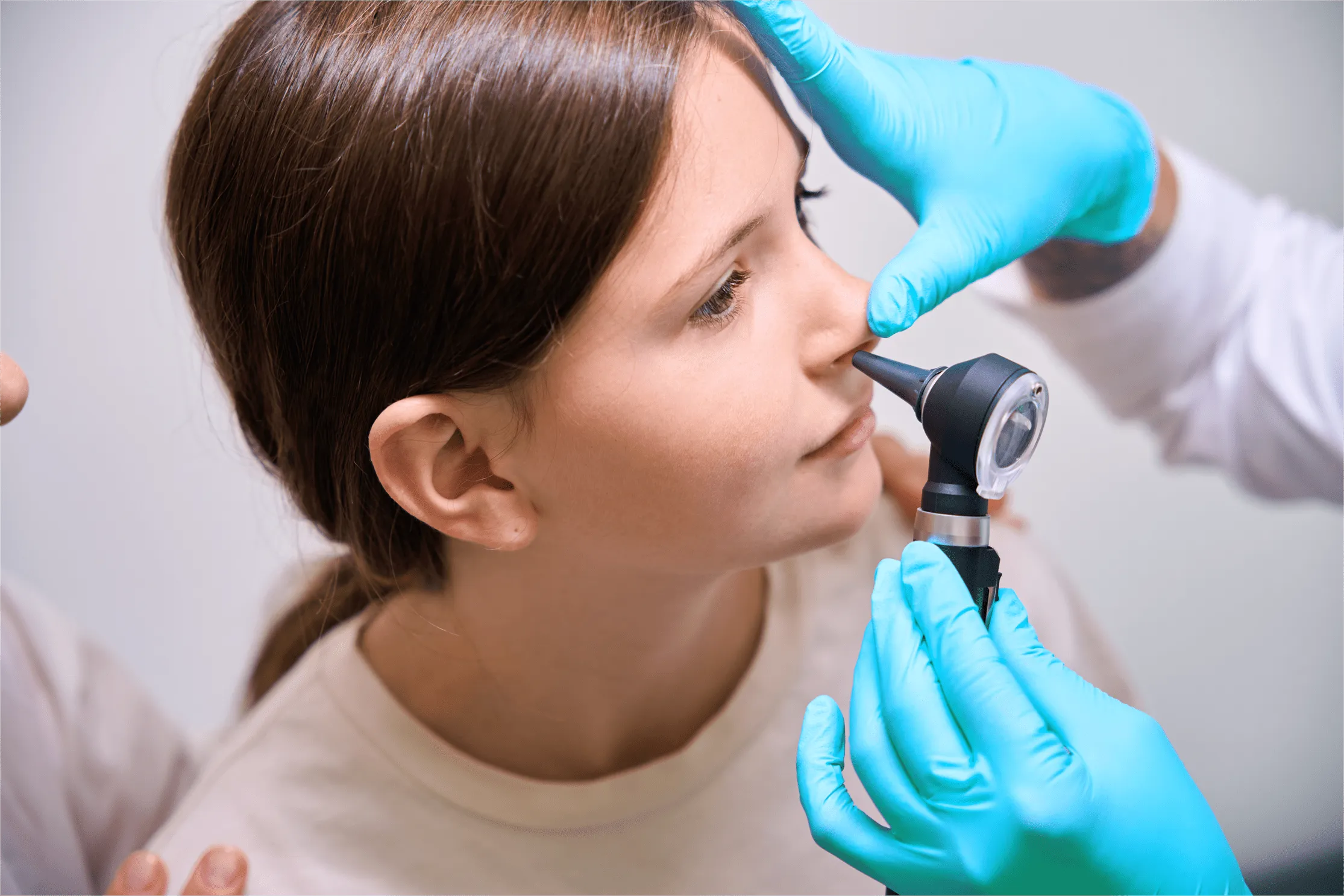otolaryngologist checking a patient's nose