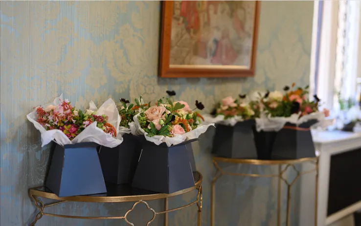 A close-up image of the bridal suite hallway at North Mymms Park, showcasing beautifully arranged fresh bouquets of bridesmaids' flowers ready to be used. The colorful and elegant bouquets add a touch of charm and sophistication to the hallway, setting the stage for the upcoming celebration.