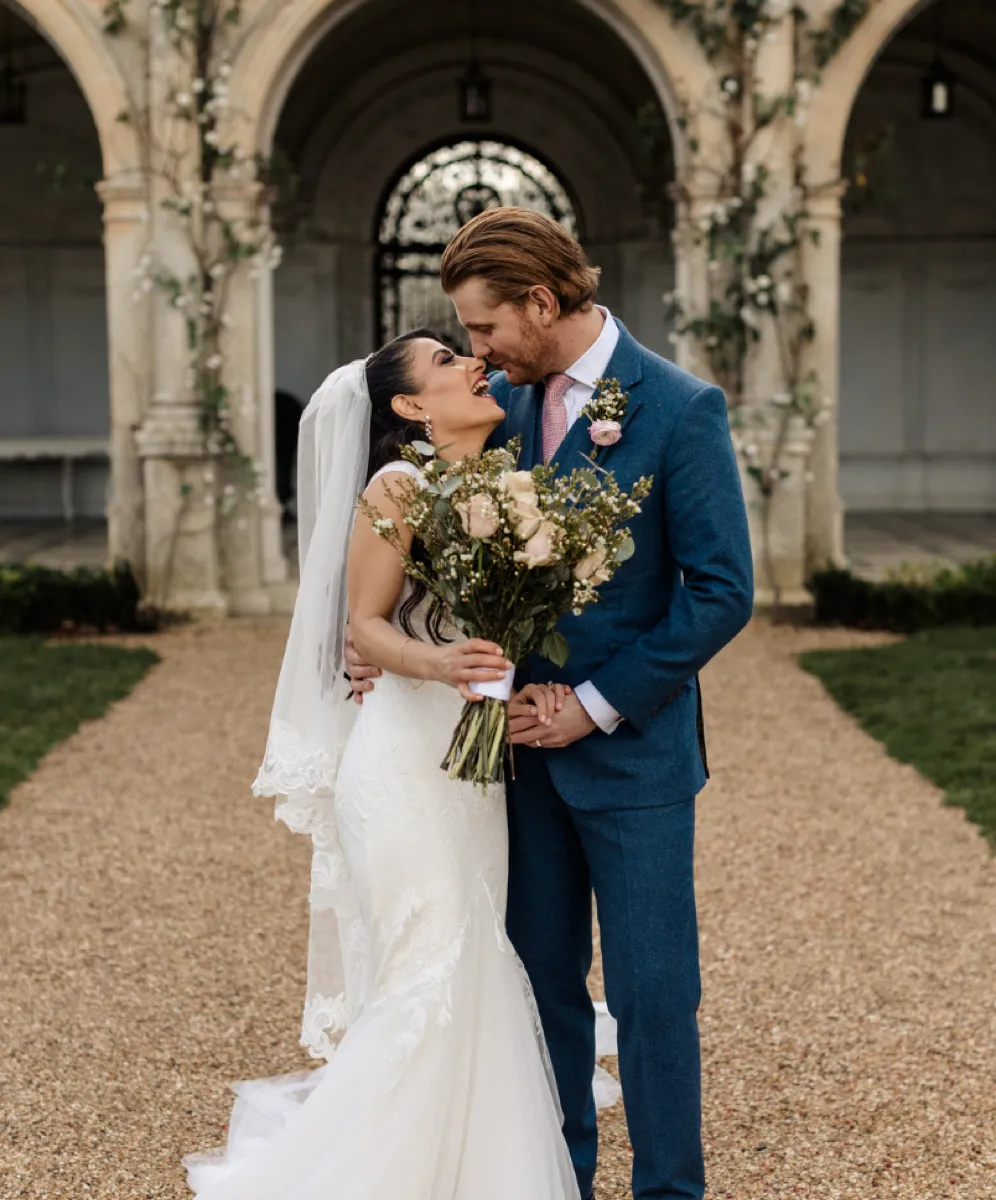 Blissful bride and groom lock eyes.the bride and groom share a tender moment, framed by the enchanting Loggia setting.